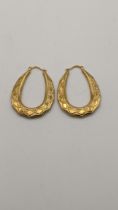 A pair of 9ct gold textured hoop earrings, total weight 2.1g Location: