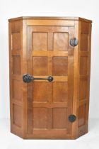 Robert 'Mouseman' Thompson (1876-1955) An oak hanging corner cupboard, circa 1955, with panelled