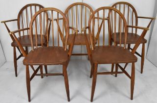 A set of five Ercol 1960s carver dining chairs, in stained elm and beech with hoop backs and spindle