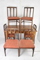 A 1960s John Herbert for A Younger & Co teak extending dining table and six chairs, the table having