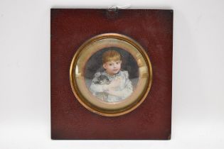 An Edwardian portrait miniature depicting a boy and a cat, watercolour on ivory, inscribed to the