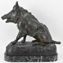 A late 19th/early 20th century French cast spelter model of a boar seated on a naturalistic