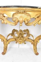 A 19th century French Louis XVI style gilt wood serpentine fronted console table, having a black