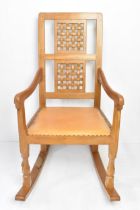 Robert 'Mouseman' Thompson (1876-1955) An oak rocking chair, circa 1974, with two lattice panel