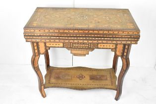 A late 19th/early 20th century Syrian Damascus games table - with typical intricate marquetry