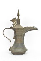 A 19th century tinned copper Dallah coffee pot, having a tapering finial and pierced triangular