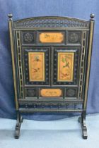 A Victorian Aesthetic movement ebonised firescreen, the top having two turned finials and pierced