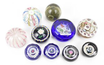A collection of ten mixed paperweights, comprising Murano latticino, Caithness lampwork floral