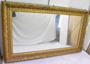 A late 19th century large wall hanging mirror, of rectangular form, the stepped frame having an