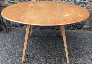 A Ercol blond elm and beech Windsor fall flap kitchen table, circa 1960s, model number 384, having