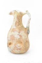 A Roman glass jug, circa 2nd to 4th century A.D, having a trefoil-lipped top, shaped handle and