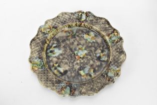 An 18th century 'Whielden' type mottled creamware plate with tortoiseshell ware decoration and