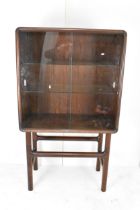 A Dyrlund 1960s exotic wood cocktail cabinet having two sliding glass doors fitted with loose