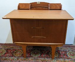 A mid 20th century Jentique metamorphic teak chest of drawers, the writing top sliding forwards