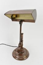 An Art Deco copper banker's desk lamp with hooded shade, over an adjustable column support to