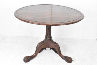 A George III mahogany tripod occasional table, having a circular top with bird cage action above a