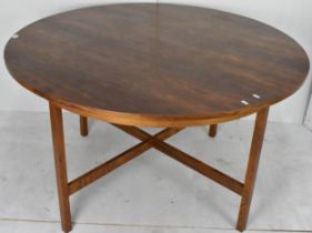 A mid 20th century Danish rosewood veneered circular topped dining table, having four block shaped