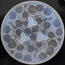 A 1930s French Art Deco pressed glass bowl by Arvers, of shallow circular form relief moulded in the