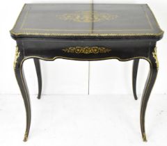 A 19th century French Louis XV style ebonised card/work table, having gilt metal floral swag