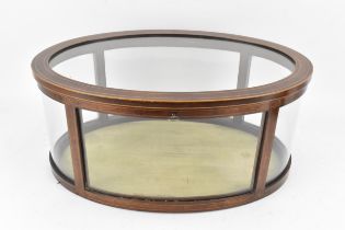 An Edwardian mahogany oval table top display cabinet, having boxwood inlaid banding with convex