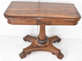 A Regency rosewood fold over card table, opening to reveal a green baize above a reeded tapering