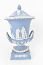A Wedgwood blue jasperware campana lidded urn, 20th century, with twin handles either side, the body