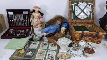 Mixed items to include a canteen of cutlery, a teapot, a picnic hamper, Meccano, postcards, silver