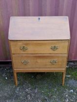 A modern light oak bureau with a fall flap over two drawers, raised on straight legs, 101h x 76w,