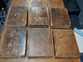 Six leather bound volumes of Matthew Henry commentaries including An Exposition of The New and Old