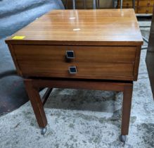 A mid century two drawer night table, on square legs and castors, 49 x 45 x 45cm, Location: