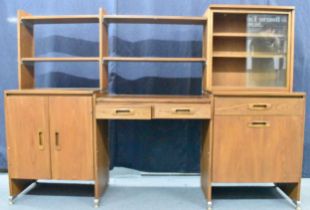 A 1960s light elm desk, having a glazed section with two sliding doors and open shelves, above