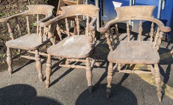 A matched set of three 19th century Captain's armchairs having turned spindle supports united by