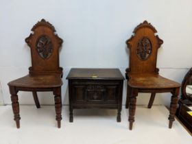 A pair of Victorian carved oak hall chairs S/F and an early 20th century oak chest of small