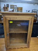 A small pine table top display cabinet, glazed door and two internal shelves, 62.5 x 47 x 22.5cm,