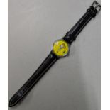 A Snoopy tennis unisex wristwatch with a quartz movement, yellow face, Arabic and baton dials on a