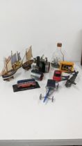 A mixed lot to include a Mamod SR1A toy tractor, a small model of a ship in a bottle sailing boats