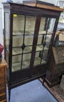 A 1920s mahogany two door glazed display cabinet on square, tapering legs, 168.5h x 91w, Location:
