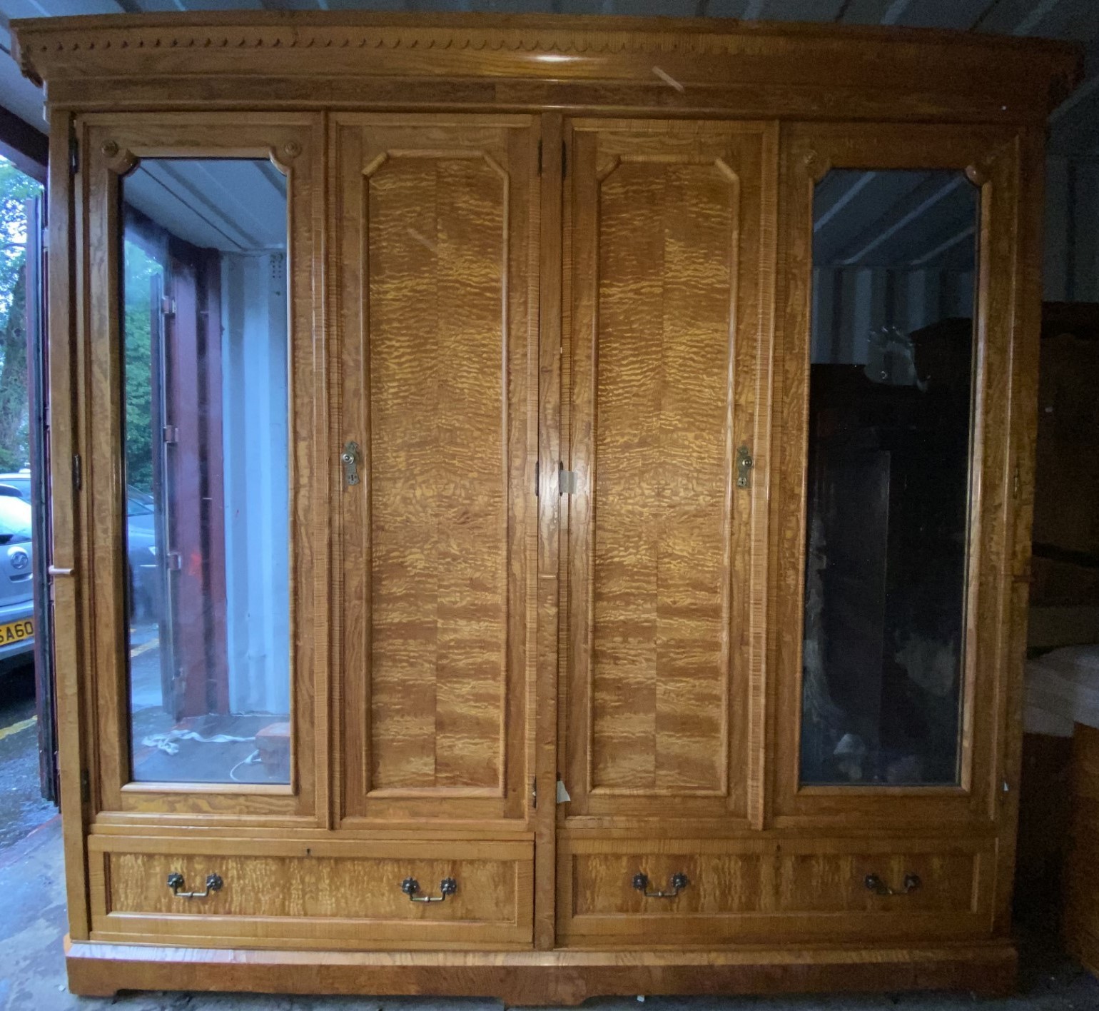 A fine late 19th century rippled ash large four door wardrobe by Christopher Pratt & Sons, Bradford,