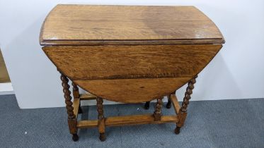 A 1930s oak barley twist gateleg table, 71.5h x 76.5w, Location: