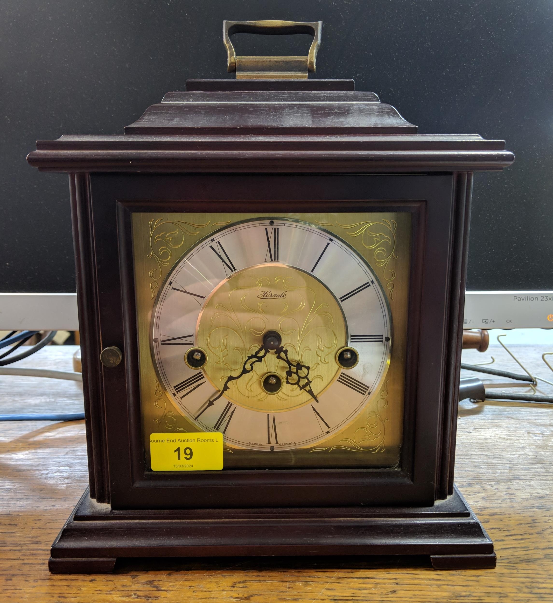 A late 10th century C Hermle German mantle clock in a mahogany finished case, the face with a