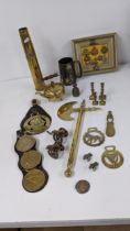 A mixed lot to include cap badges and re-strikes, a shot gun casing, horse brass a white metal badge