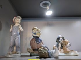 A group of Lladro and Nao porcelain figurines and animal model groups, to include one of a boy