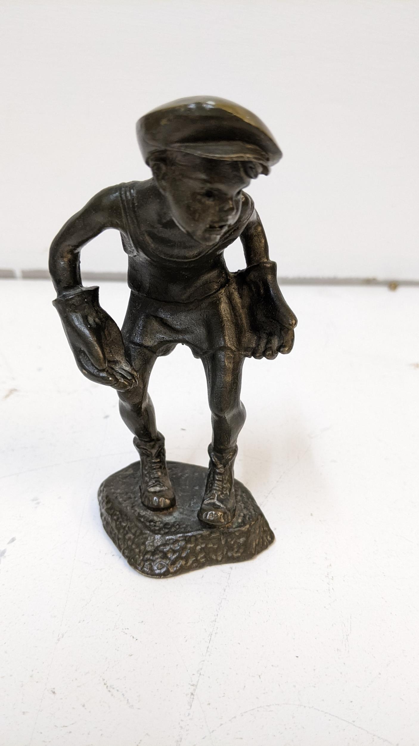 A 1930's cast bronze figure of a boy wearing a cap and oversized gloves, stamped H M Mop, 13cm h