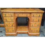 A fine late 19th century rippled ash knee-hole nine drawer desk by Christopher Pratt & Sons,