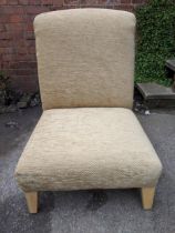 A modern beige fabric upholstered low chair on beech legs, Location: