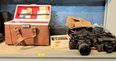 Photographic equipment to include a Praktica B100, A Cannon AE-1, a Holga 200m lens and other items,