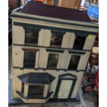 A large Victorian/Edwardian painted wooden dolls house, in the Georgian town house style, three