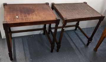 A pair of modern occasional tables having brown leather tops with mahogany finished turned legs,