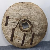 An antique wall mounted wheel, possibly a Japanese ox cart wheel, 76cm diameter Location: