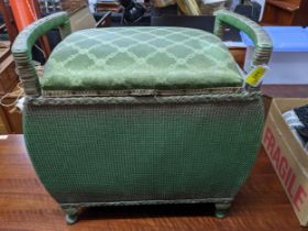 A Lloyd Loom style dressing table stool with upholstered, hinged seat, carrying arms, in original